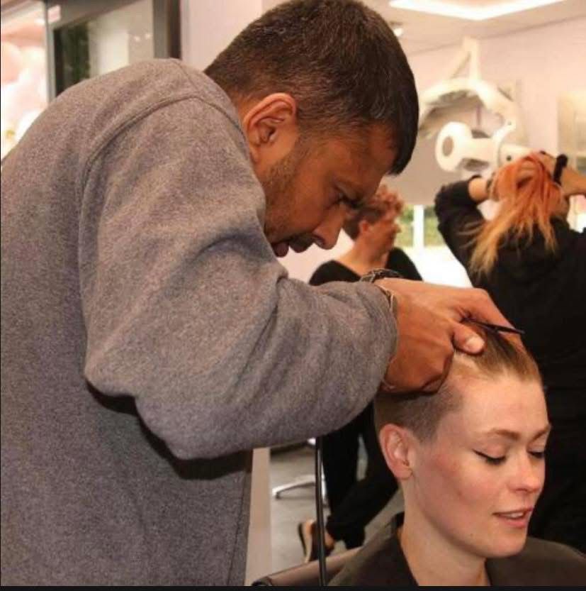 Stylist cutting hair with scissors at HQ Salon Reading